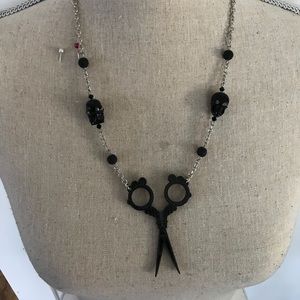Neckless with scissor and skulls on the chain